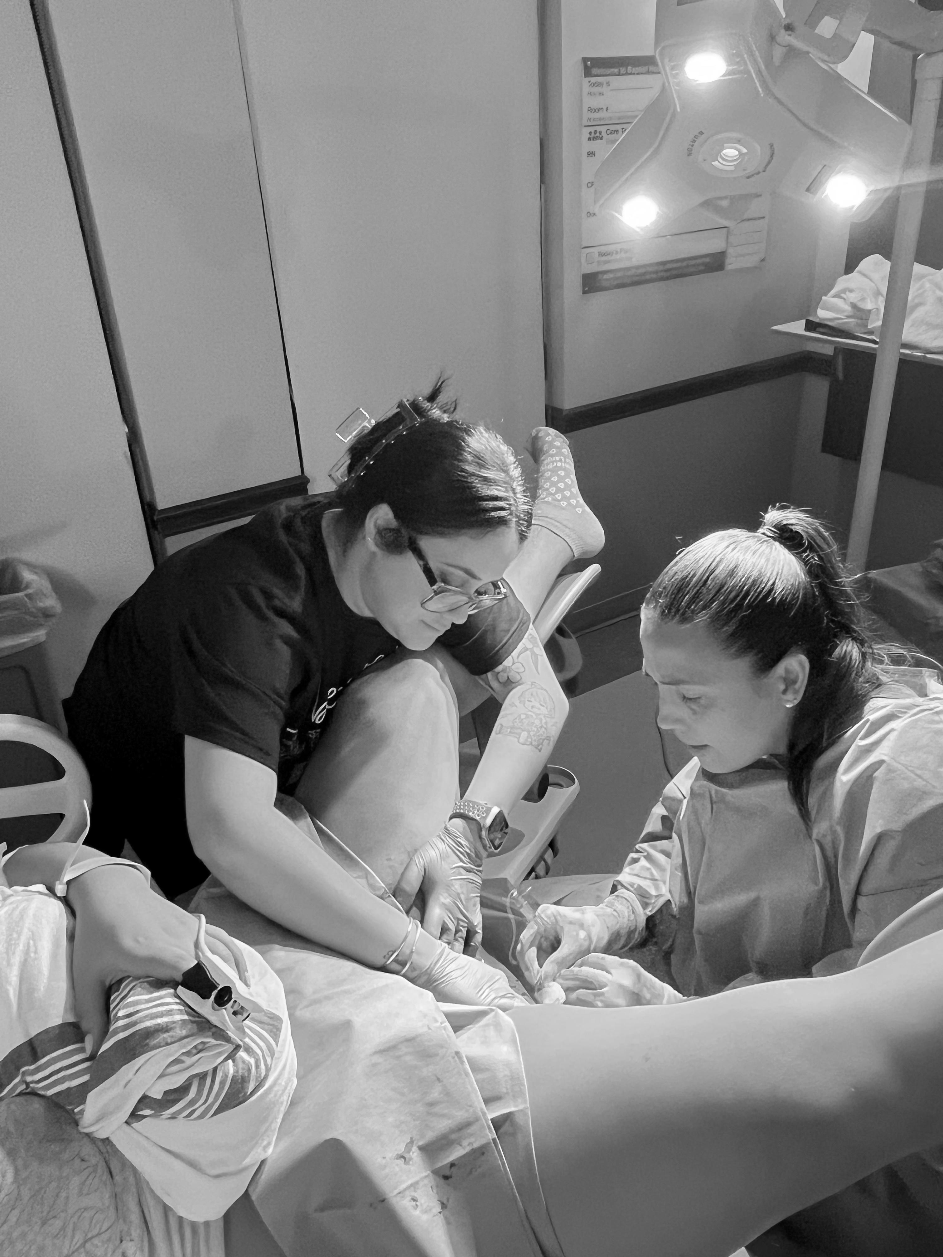Doula comforting a mother during labor at a South Florida hospital