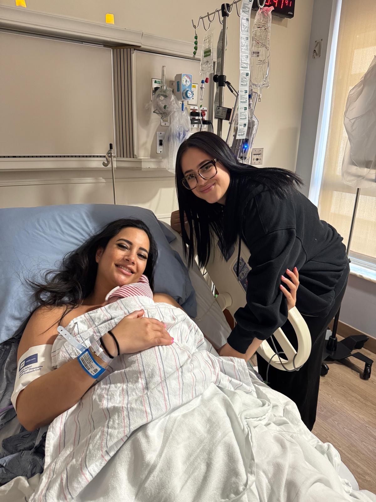 Blooming Bellies birth support client holding her newborn