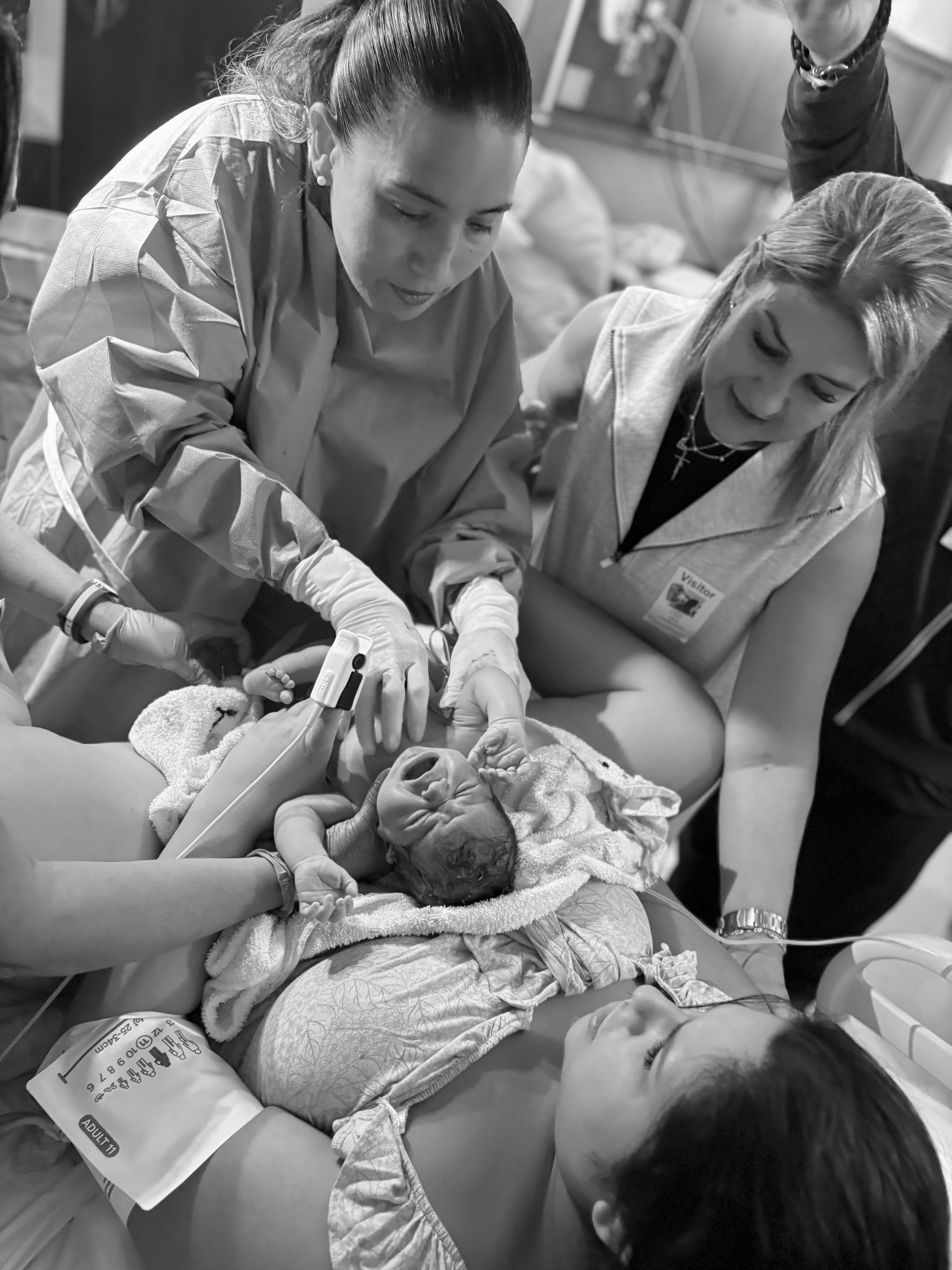 A birth team caring for a mom and her baby moments after birth