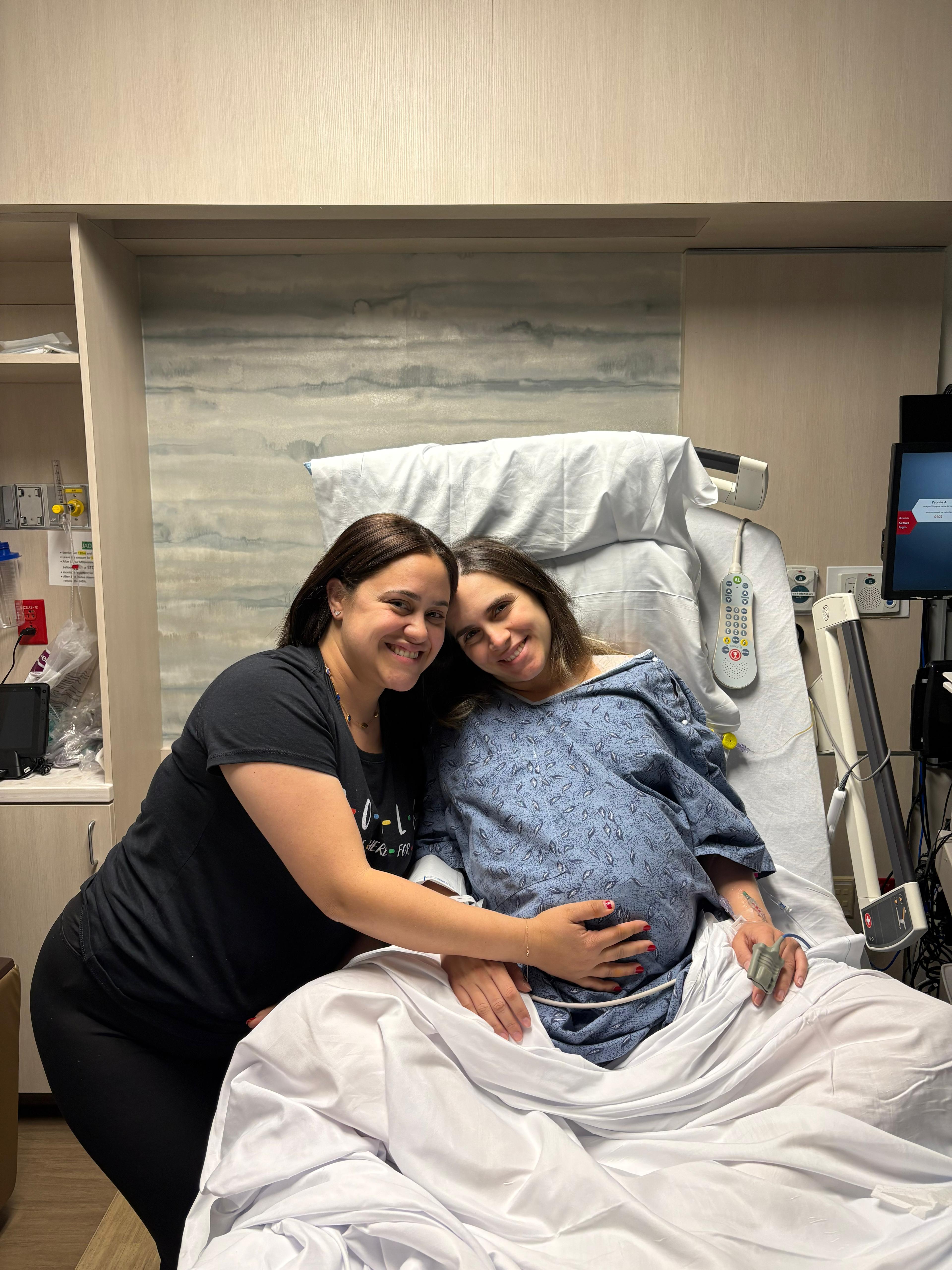 Rosy comforting a mom during labor in her hospital bed